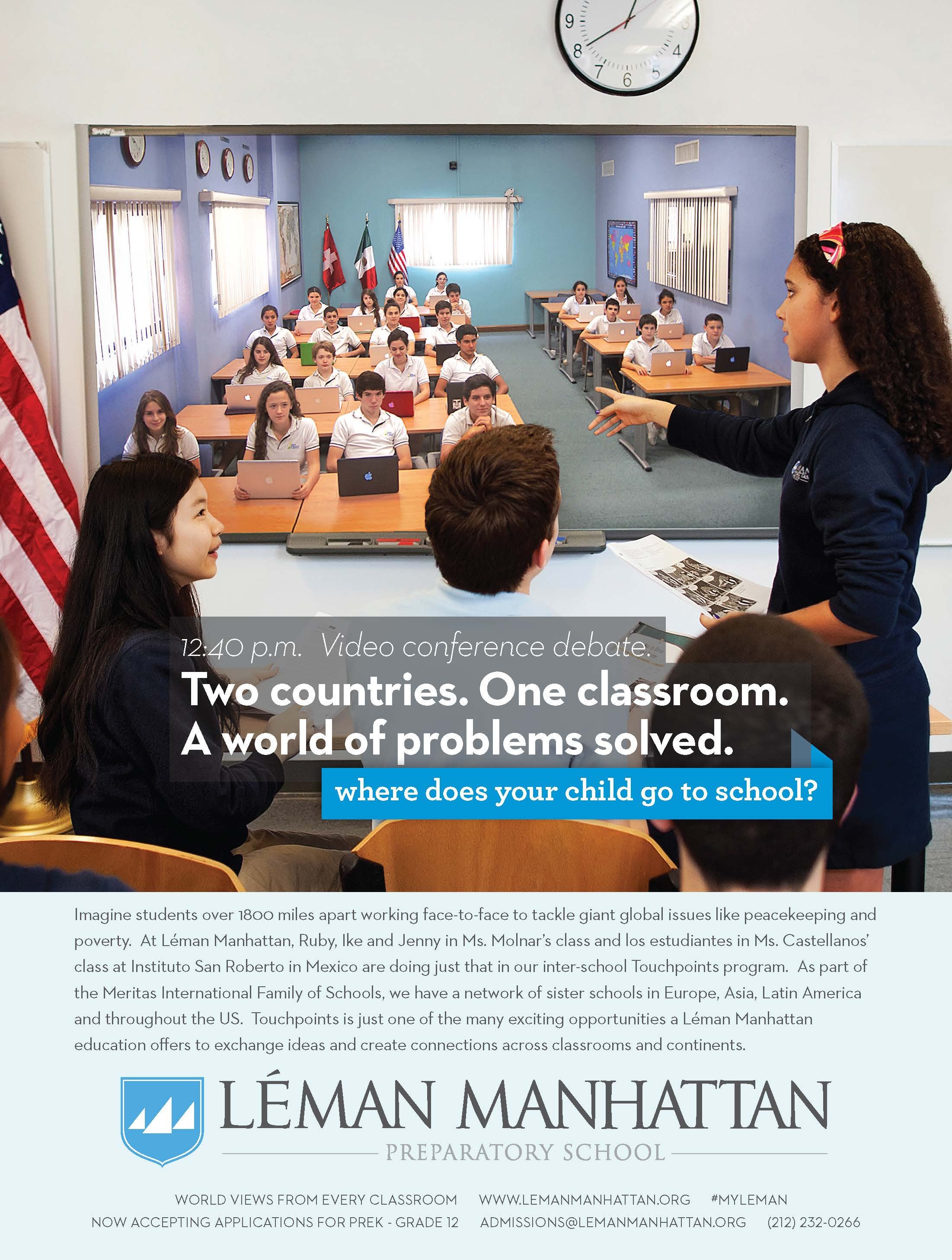 A classroom with students working on laptops, facing a teacher standing in front of a large video conference screen. The screen displays students from another classroom participating in a debate. Flags of the United States, Mexico, Canada, and Italy 