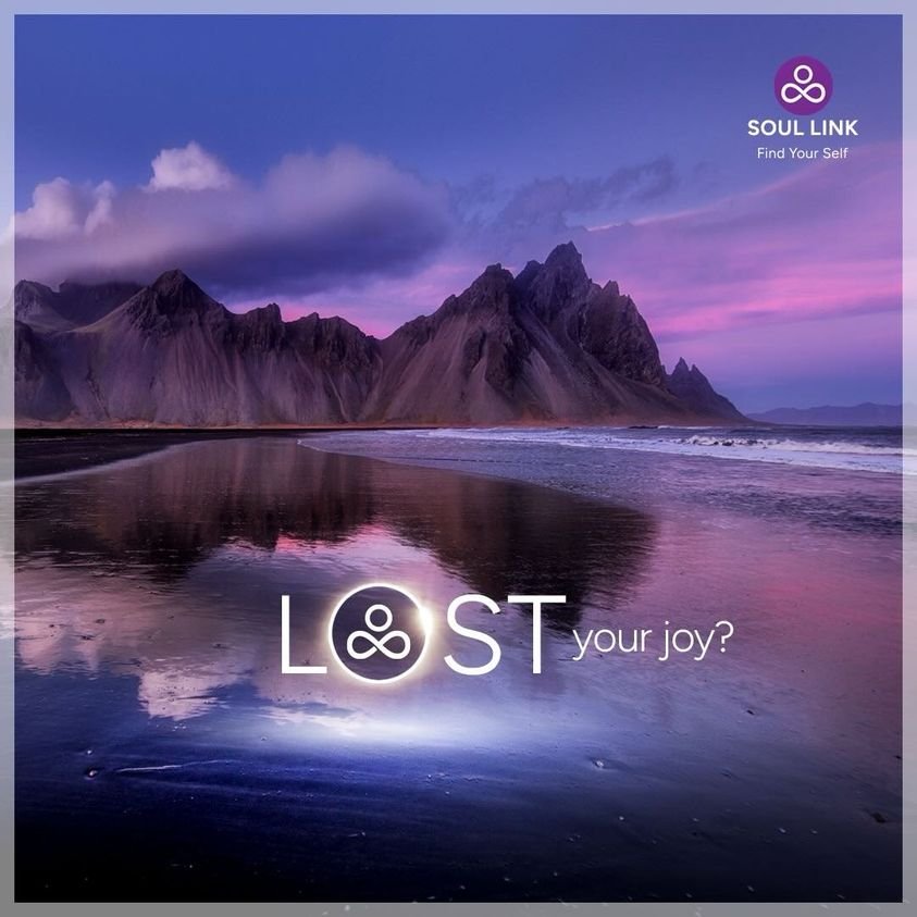 A scenic view of a mountain range and calm beach at sunset with purple and pink hues in the sky. Text overlay reads "LOST your joy?" with a logo and the words "SOUL LINK Find Your Self" in the top right corner.
