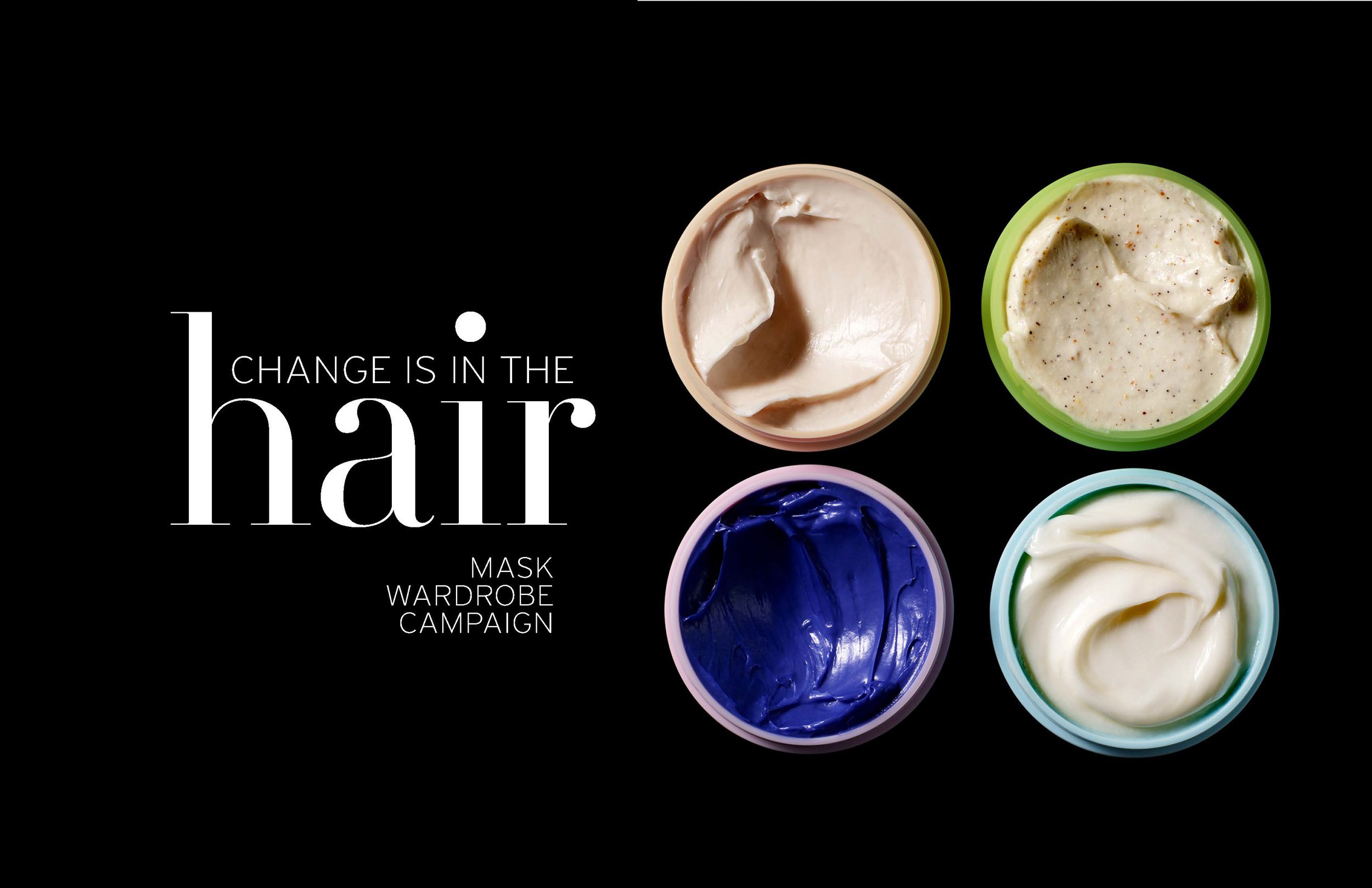 Four containers of different hair masks in beige, green, purple, and blue, with text that reads, 'Change is in the hair mask wardrobe campaign' on a black background.