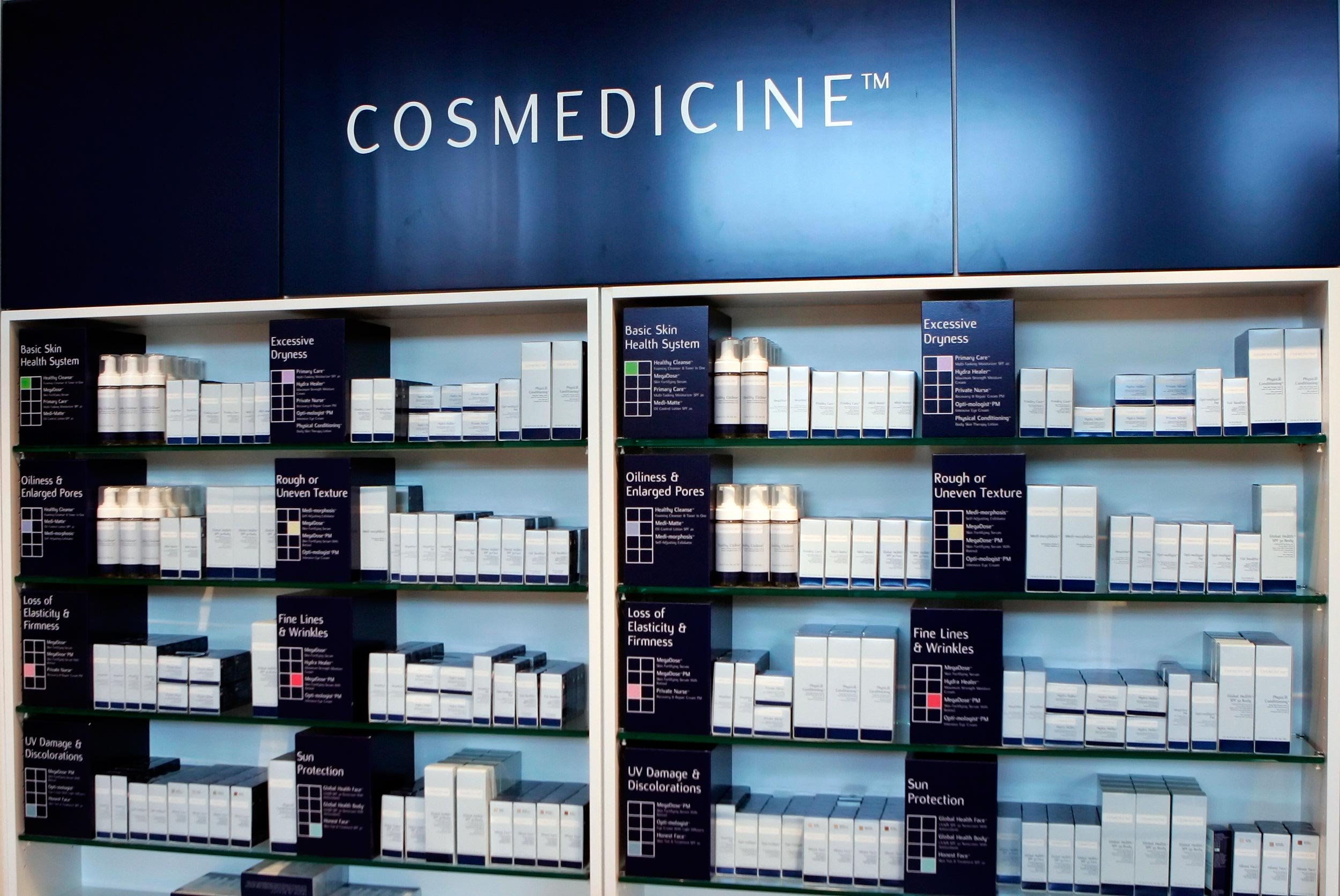 Display shelves with skincare products labeled for various skin concerns, within a section titled 'COSMEDICINE'.