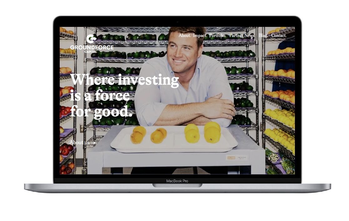Laptop screen displaying a man smiling in a produce storage room with shelves of fruits and vegetables. The website text says: "Where investing is a force for good."