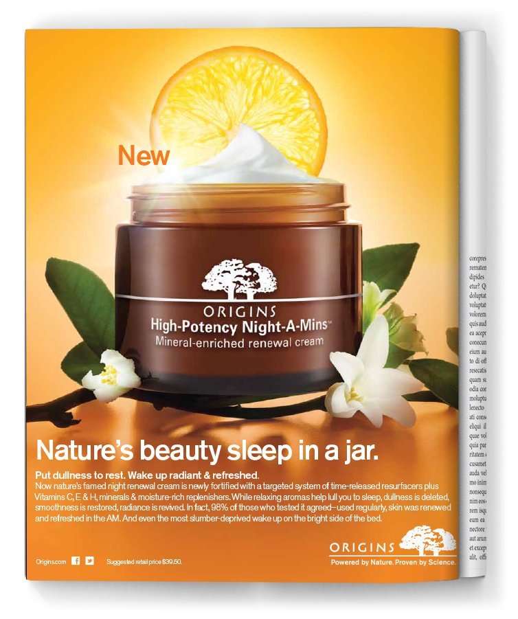 An advertisement for Origins High-Potency Night-A-Mins moisturizing cream featuring an open jar of cream with whipped texture, a lemon slice behind it, white flowers, and green leaves. Text highlights its revitalizing properties and new formula.